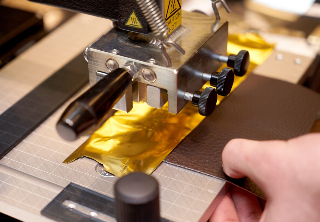 close up image of a hot foil stamping machine being prepared for use.