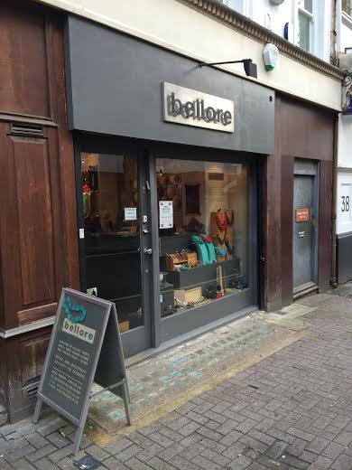 Storefront with 'bellore' branding on a city street