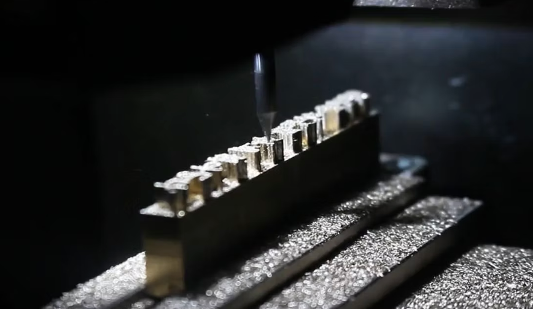 Close-up of the redt rubo-c3 in action, it shows a drill milling away at a brass block.