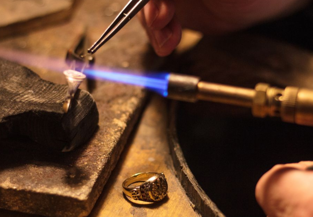 close up image of a jewellery torch with an active flame on a ring.